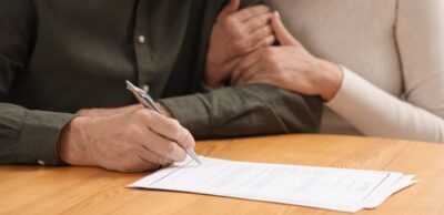 senior couple signing probate papers